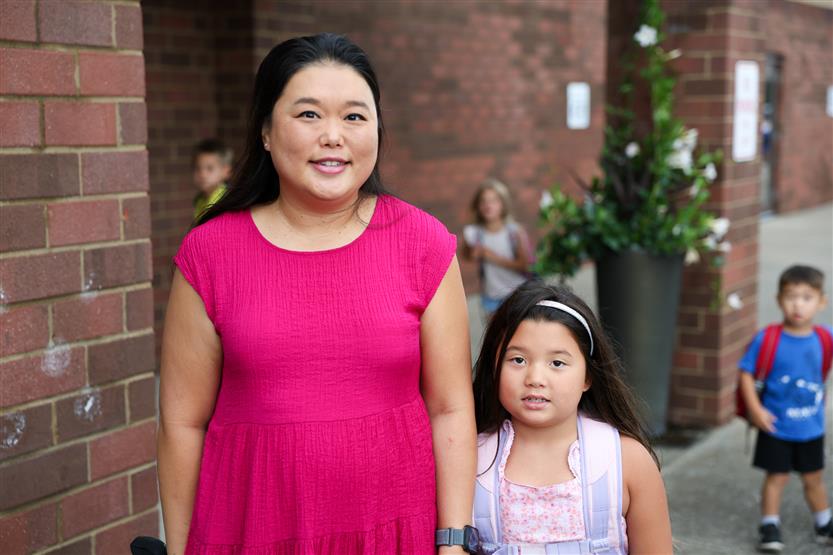 Students smile on the first day of kindergarten